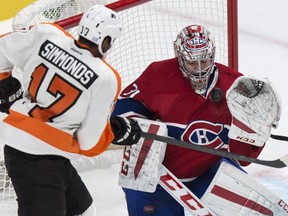 Montreal Canadiens goalie Carey Price stops a shot by Philadelphia Flyers' Wayne Simmonds during the second period of their NHL hockey game in Montreal on Saturday, Nov. 15, 2014.