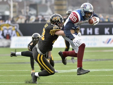 Hamilton Tiger-Cats defensive back Craig Butler (left) tackles Montreal Alouettes receiver Duron Carter during second half action in the CFL Eastern Division final in Hamilton, Ont., on Sunday, Nov. 23, 2014.