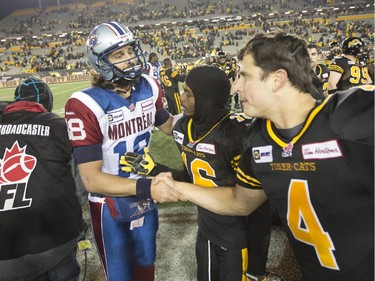 Hamilton Tiger-Cats quarterback Zach Collaros (4) shakes hands with Montreal Alouettes quarterback Jonathan Crompton (18) following the end of CFL football action in Hamilton, Ont., on Saturday, November 8, 2014. The Tiger-Cats defeated the Alouettes 29-15 to become the Eastern Division Champions, eliminating the Toronto Argonauts.