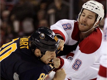 Buffalo Sabres right winger Chris Stewart (80) gets hit with a punch from Montreal Canadiens left winger Brandon Prust (8) during a fight in the first period of an NHL hockey game Friday, Nov. 28, 2014, in Buffalo, N.Y.