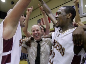 Concordia Stingers players Patrick Perrotte (left) and Dwayne Buckley celebrate their Quebec league championship victory over Laval with head coach John Dore at Concordia on March 9, 2007.