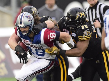 Montreal Alouettes quarterback Jonathan Crompton is sacked by Hamtilon Tiger-Cats defensive end Bryan Hallduring second half action in the CFL Eastern Division final in Hamilton, Ont., on Sunday, Nov. 23, 2014.