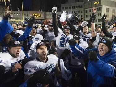 Montreal Carabins head coach Danny Maciocia, right, celebrates with his team after beating the McMaster Marauders in the CIS Vanier Cup football final in Montreal Saturday, November 29, 2014.