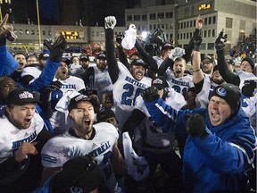 Carabins head coach Danny Maciocia, right, celebrates with his team after beating the McMaster Marauders in the Vanier Cup at Molson Stadium on Nov. 29, 2014.