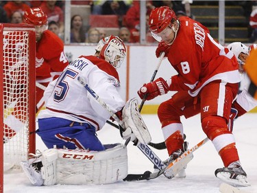 Montreal Canadiens goalie Dustin Tokarski (35) stops a Detroit Red Wings left wing Justin Abdelkader (8) shot in the first period of an NHL hockey game in Detroit, Sunday, Nov. 16, 2014.