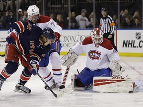 Montreal Canadiens goalie Dustin Tokarski , right, makes a save during the second period of the NHL hockey game against the New York Rangers, Sunday, Nov. 23, 2014, in New York. Forbes has come out with its annual rankings of the value of each NHL team, and for the first time the Canadiens are a $1-billion franchise.