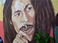 Mural depicting reggae music icon Bob Marley decorates a wall in the yard of Marley's Kingston home in Jamaica.