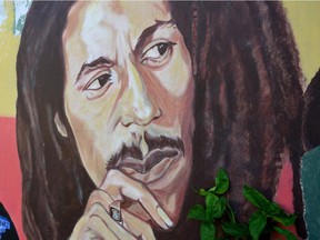 Mural depicting reggae music icon Bob Marley decorates a wall in the yard of Marley's Kingston home in Jamaica.