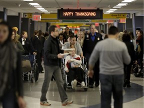 Travelers walk through LaGuardia Airport in New York in November 2014.