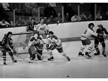 A rare photo of the Montreal Canadiens' Big Three on the ice at the same time during a game at the Montreal Forum in 1975-76. Around Canadiens goalie Michel Larocque are New York Rangers' Steve Vickers (left), Rangers' Jean Ratelle and Canadiens' Larry Robinson (behind the net), Guy Lapointe (in front of Larocque), and Canadiens' Serge Savard and Rangers' Rick Middleton (at right).