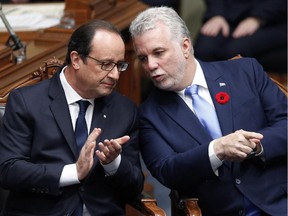 French President Francois Hollande, left, chats with Quebec Premier Philippe Couillard, Tuesday, November 4, 2014 at the National Assembly in Quebec City.