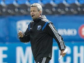 Impact head coach Frank Klopas directs a practice in Montreal on Aug. 14, 2014.