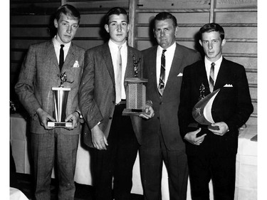 Future Montreal Canadiens defenceman Guy Lapointe (second from left), here a teenaged minor-hockey player, accepts a trophy from Canadiens legend Maurice Richard at an awards banquet in the mid-1960s.