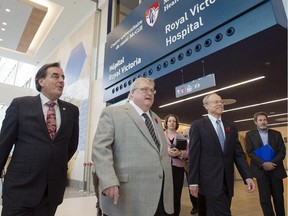 Quebec Health Minister Gaétan Barrette, centre, MUHC chief executive Normand Rinfret, left, and SNC-Lavalin chief executive Robert Card, right. tour the new McGill University Health Centre (MUHC) super-hospital Friday, November 7, 2014 in Montreal.