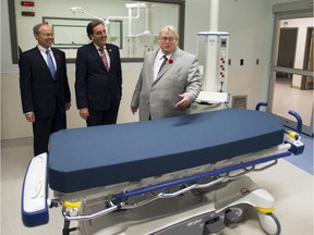 Quebec Health Minister Gaetan Barrette,right, MUHC chief executive Normand Rinfret, center, and SNC-Lavalin chief executive Robert Card, left, tour the new McGill University Health Centre (MUHC) super-hospital Friday, November 7, 2014 in Montreal.