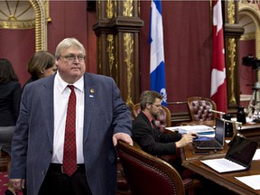 Quebec Health Minister Gaetan Barrette arrives at a legislature committee on health Thursday, November 13, 2014 at the National Assembly in Quebec City.