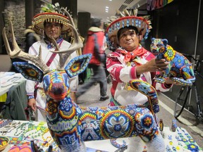 Enrique Ramirez. left, and Jose Luis Ramirez of Mexico at Concordia University, Monday, Nov. 24, 2014, before a screening of Huicholes: The Last Peyote Guardians. They made the beaded animals and jewelry.