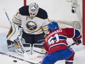 Buffalo Sabres goaltender Jhonas Enroth makes a save against Montreal Canadiens' David Desharnais during second period NHL hockey action in Montreal, Saturday, November 29, 2014.