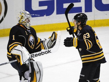 Buffalo Sabres goaltender Jhonas Enroth (1), of Sweden, celebrates with centre Tyler Ennis (63) after the third period of an NHL hockey game against the Montreal Canadiens Friday, Nov. 28, 2014, in Buffalo, N.Y. Buffalo won 2-1.