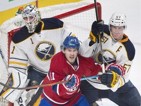 Buffalo Sabres goaltender Jhonas Enroth (1) keeps an eye on the play as teammate Tyler Myers, right, defends against Montreal Canadiens' Brendan Gallagher during first period NHL hockey action in Montreal, Saturday, November 29, 2014.