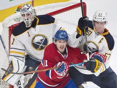 Buffalo Sabres goaltender Jhonas Enroth (1) keeps an eye on the play as teammate Tyler Myers, right, defends against Montreal Canadiens' Brendan Gallagher during first period NHL hockey action in Montreal, Saturday, November 29, 2014.
