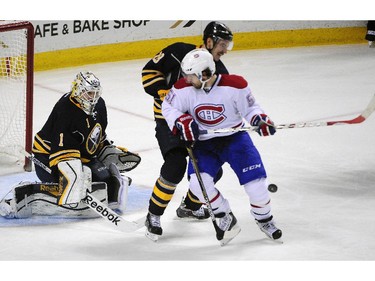 Buffalo Sabres goaltender Jhonas Enroth (1), of Sweden, watches the incoming shot as Sabres centre Zemgus Girgensons (28), of Latvia, and Montreal Canadiens centre David Desharnais (51) tangle in front during the third period of an NHL hockey game Friday, Nov. 28, 2014, in Buffalo, N.Y.  Buffalo won 2-1.