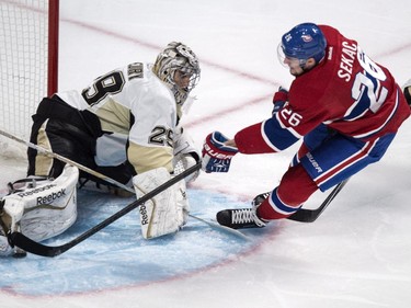 Pittsburgh Penguins goalie Marc-Andre Fleury stops Montreal Canadiens' Jiri Sekac during first period NHL hockey action Tuesday, November 18, 2014 in Montreal.