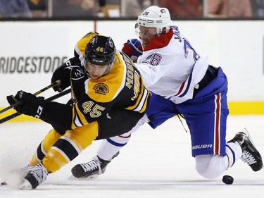 Boston Bruins' Joe Morrow (45) and Montreal Canadiens' Jiri Sekac battle for the puck during the first period of an NHL hockey game in Boston, Saturday, Nov. 22, 2014.