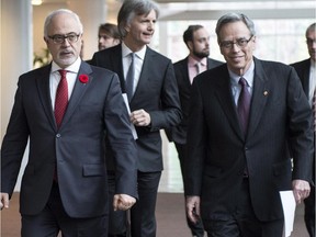 Federal Finance Minister Joe Oliver, right, and his Quebec counterpart, Carlos Leitao, arrive at a news conference to announce the creation of a capital-risk fund in Quebec Monday, November 10, 2014 in Montreal.