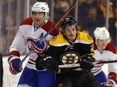 Boston Bruins' Loui Eriksson, front right, checks Montreal Canadiens' Max Pacioretty during the first period of an NHL hockey game in Boston, Saturday, Nov. 22, 2014.