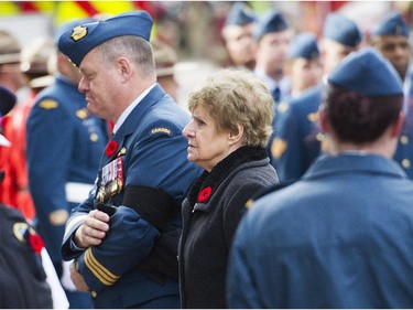 Lt. Col. Gilbert McCauley escorts warrant officer Patrice Vincent's mother Guerette Vincent into a cathedral in Longueuil, Que., Saturday, Nov. 1, 2014 her son's funeral. Patrice Vincent died after being hit by a car driven by an attacker with known jihadist sympathies on Oct. 20 in the parking lot of a shopping mall in Saint-Jean-sur-Richelieu, southeast of Montreal.