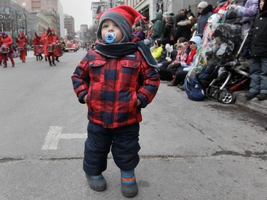 Two-year-old Massimo Sauvé took in the Santa Claus parade on Ste-Catherine St. in Montreal Saturday, November 22, 2014. It was  the 64th edition of the Santa Claus parade.