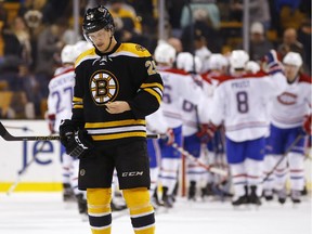 The Bruins' Matt Fraser skates off the ice as the Canadiens celebrate their 2-0  win in Boston on Nov. 22, 2014.