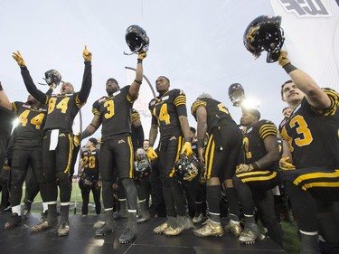 Members of the Hamilton Tiger-Cats celebrate after defeating the Montreal Alouettes in the CFL Eastern Division Final in Hamilton on Sunday November 23, 2014.