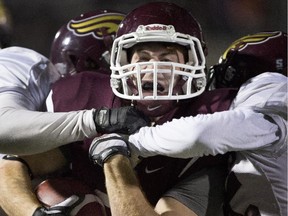 McMaster Marauders' Daniel Vanderoort gets tackled by the Mount Allison Mounties during the second half CIS 2014 Mitchell Bowl action in Hamilton on Saturday, November 22, 2014.