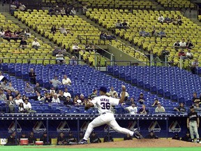 The Expos' Tony Armas Jr. pitches in front of a very small crowd at Olympic Stadium during a Major League Baseball game on May 2, 2001.