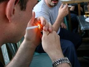 Two men smoke on the terrasse at Ye Olde Orchard on Monkland Ave.