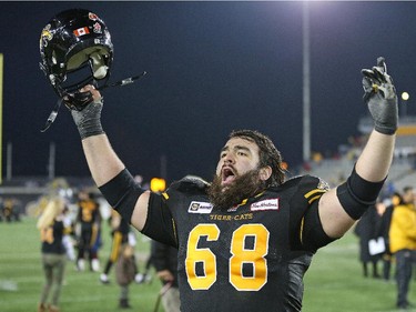 Mike Filer #68 of the Hamilton Tiger-Cats celebrates a win against the Montreal Alouettes in a CFL football game at Tim Hortons Field on November 8, 2014 in London, Ontario, Canada. The Tiger-Cats defeated the Alouettes 29-15.