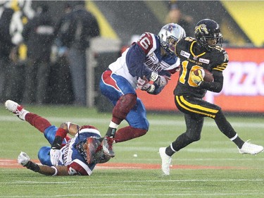Brandon Banks #16 of the Hamilton Tiger-cats breaks a couple of tackles against the Montreal Alouettes in a CFL football game at Tim Hortons Field on November 8, 2014 in Hamilton.