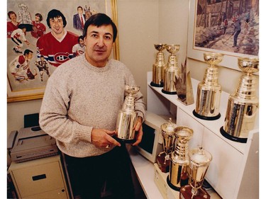 Montreal Canadiens defenceman Guy Lapointe at home in this undated photo with six miniature Stanley Cups, representing his championships won with the Habs, with other trophy miniatures.