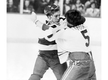 Montreal Canadiens defenceman Guy Lapointe (right) squares off with Toronto Maple Leafs' Dave (Tiger) Williams during a 1970s game.