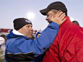 Montreal Carabins head coach Danny Maciocia, left, meets with Laval Rouge et Or coach Glen Constantin on Nov. 15, 2014 after the Dunsmore Cup game  in Quebec City. The Carabins won the game 12-9 in overtime.