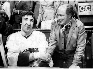 MONTREAL, May 9, 1976: Montreal Canadiens defenceman Guy Lapointe accepts Montreal Forum rinkside congratulations from Prime Minister Pierre Trudeau. Lapointe had scored the winning goal with 2:22 to play in the Habs' 4-3 win over the Philadelphia Flyers in Game 1 of the Stanley Cup final. The Habs would sweep the Flyers in four straight to win the Stanley Cup.
