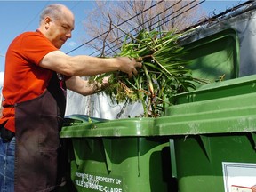 Peter Pickrell dumps waste into city of Pointe-Claire compost bins outside Westmount Florists in Pointe-Claire. Westmount Florists are the first business to participate in the new compost-recycling program.