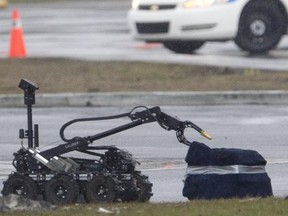 A Montreal police robot approches a suspicious package in Pointe Claire in 2013.