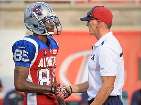 Alouettes coach Jeff Garcia greets receiver Chad Johnson before CFL game against the Edmonton Eskimos at Molson Stadium on Aug. 8, 2014.