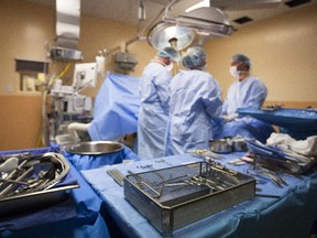 Surgical instruments are placed on a sterile table during kidney transplant surgery.