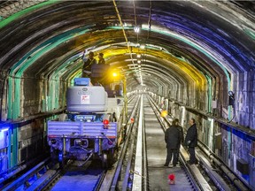 Workers verify weak and damaged areas in the concrete inside the STM yellow line metro tunnel in Montreal on Friday, February 14, 2014. The yellow metro line, which passes under the St. Lawrence river, will be undergoing repairs in the spring and fall to repair water leaks. The repairs will cause the closure of the line for 25 weekends in 2014. (Dario Ayala / THE GAZETTE) ORG XMIT: 49123