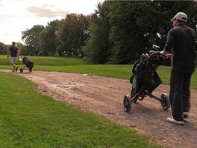 Golfers head out onto the Meadowbrook Golf Course in August.