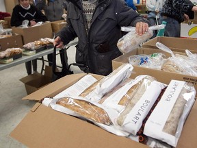 A man picks up bread at a food bank on Hochelaga St. in Montreal on Jan. 12, 2012.